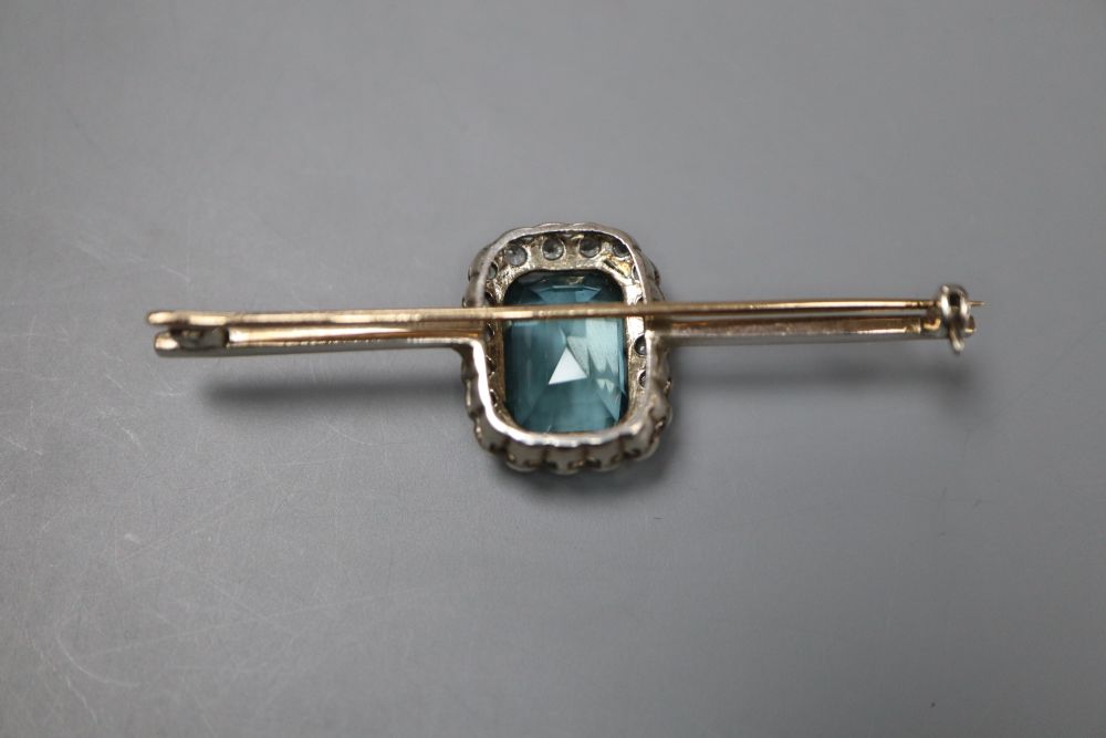 A white and yellow metal, emerald cut aquamarine and white topaz set bar brooch, 6cm, gross 7.2 grams.